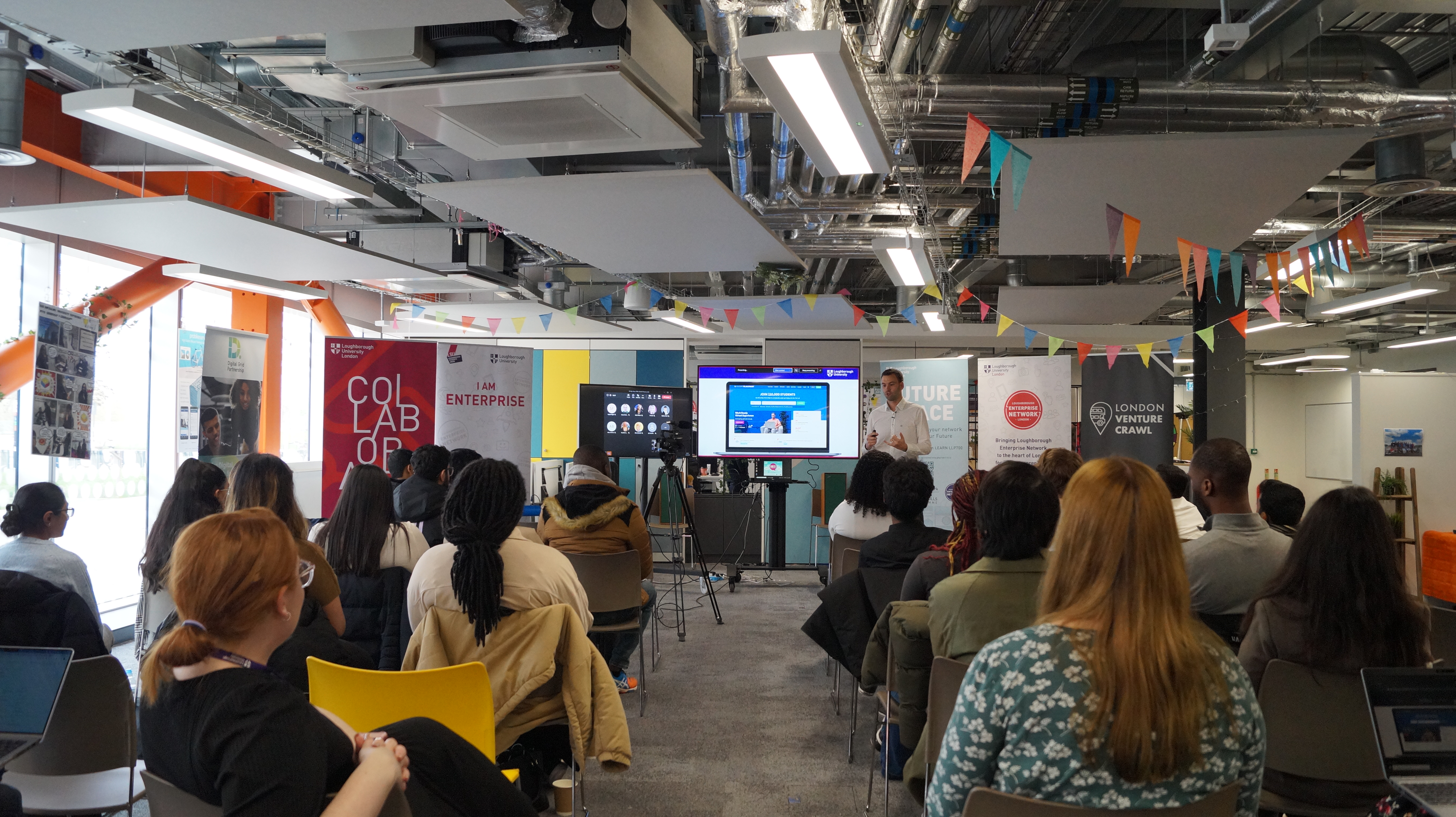 A presenter in front of 20 students